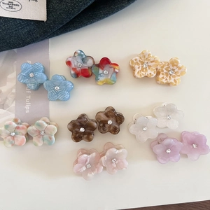 Mini floral acetate hair claws with rhinestones in eight assorted vibrant colors