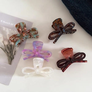 Set of five elegant acetate bow hair claws in tortoiseshell and marble patterns