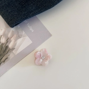 Detailed view of pink marble flower hair claw clip with crystal rhinestone center decor