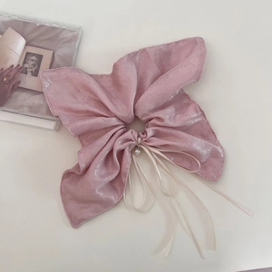 Elegant pink pearlescent silk bow hair tie with pearl charms and long flowing ribbons