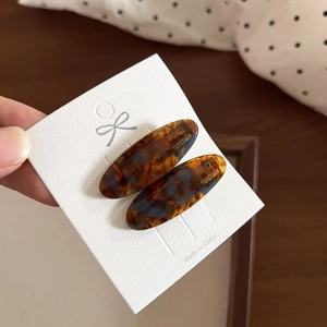 Detailed macro of tortoiseshell acetate hair clips with France Handmade gold lettering