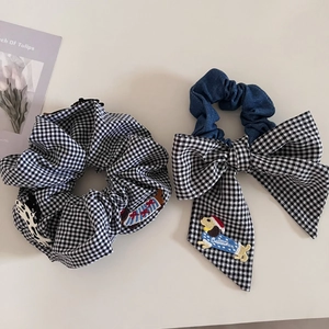 Detail of dachshund embroidery on plaid bow scrunchie and vintage gingham hair tie