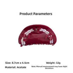 Detail view of the red cherry pattern acetate hair claw showing 8.7cm length and 4.5cm size