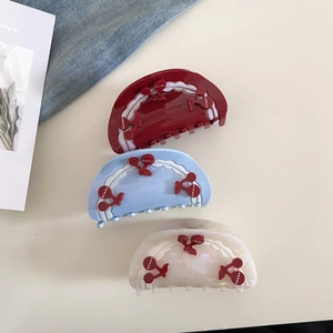Three-piece large hair claw set with cherry 3D accents in red, blue, and cream white