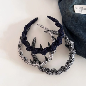 Detail view of woven fabric headbands with polka dots, stripes, and non-slip inner teeth