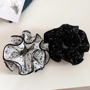 Detail of oversized floral scrunchies with four-layer pleats and contrast piping