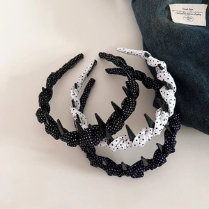 Close-up of handmade fabric headbands with polka dots and non-slip plastic teeth