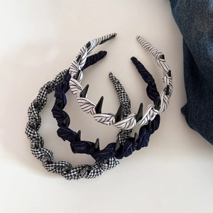 Detail of three fabric headbands with polka dots and stripes featuring black plastic teeth