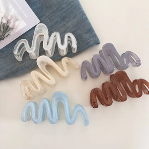 Detailed collection of wavy acrylic hair claws in assorted pastel and creamy colors