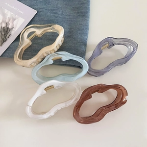 Set of large jelly-colored cloud hair claws in assorted pastel tones on a soft background