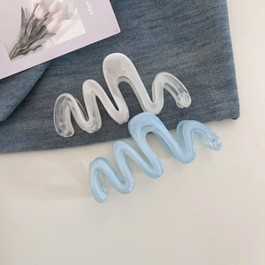 Large wave hair claws in white and blue resin for elegant summer hairstyles on denim
