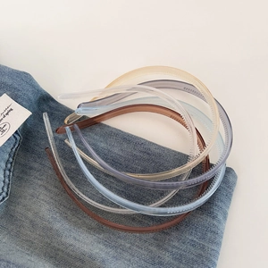 Detail view of non-slip jelly color headbands with teeth on blue denim background