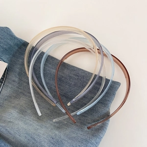 Detail of colorful translucent non-slip headbands with inner teeth on denim background