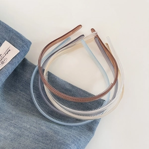 Close-up of minimalist jelly color headbands with anti-slip teeth on denim texture