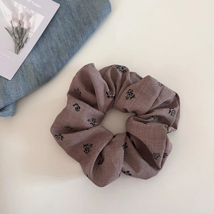 Detail of vintage large brown floral scrunchie with rose print and soft fabric texture