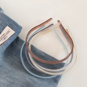 Detail view of multi-color non-slip jelly hairbands with inner teeth on denim background