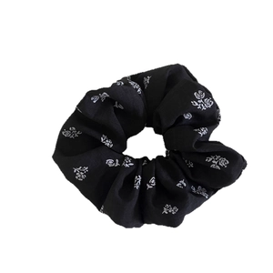 Vintage black floral scrunchie with white rose print for elegant bun hairstyles