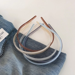 Minimalist jelly color non-slip headbands with teeth on blue denim background