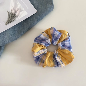 Sweet plaid patchwork scrunchie with yellow and blue fabric for women's hair styling