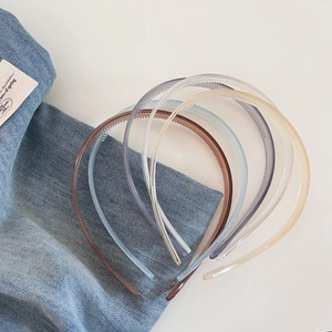 Detail view of colorful jelly-colored resin headbands with non-slip teeth for women