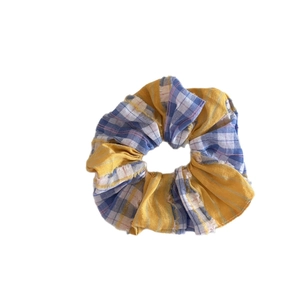 Sweet plaid scrunchie in yellow and blue checkered fabric for elegant women's hairstyles