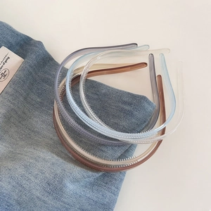 Detail of translucent jelly hairbands with non-slip teeth on denim background