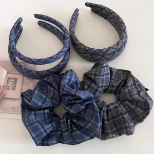 Detail of five-piece navy blue plaid hair accessory set including headbands and scrunchies