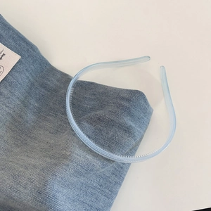 Detailed macro view of the non-slip inner teeth of a light blue jelly hairband
