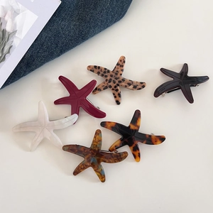Detailed set of acetate starfish hair clips in leopard, amber, and solid colors