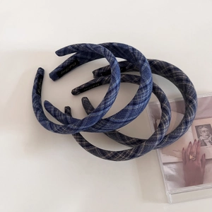 Detailed view of three navy plaid wide headbands with elegant crosshatch patterns