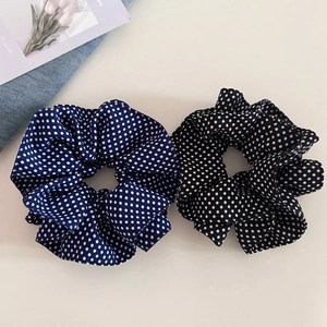 Two-piece navy and black polka dot scrunchie set with soft pleated fabric texture