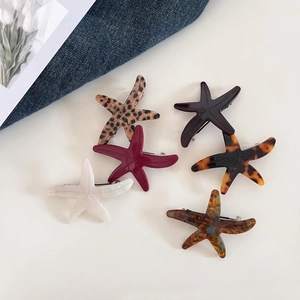 Detail view showing six acetate starfish hair clips in leopard and marble patterns