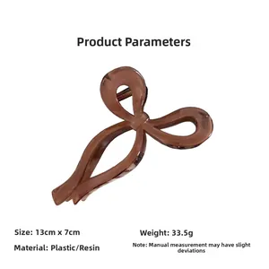 Detailed view of brown bow hair claw clip with 13cm size specifications and resin material