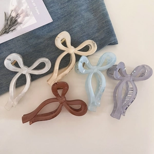 Detailed collection of five colorful ribbon bow hair claws in diverse aesthetic shades
