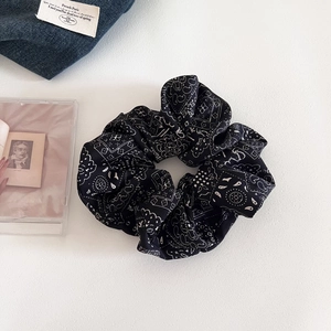 Retro black paisley oversized scrunchie with white patterns for elegant hair styling
