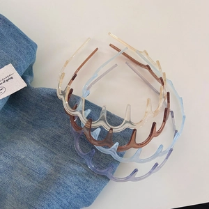 Detailed view of translucent wavy headbands with non-slip teeth in various Morandi colors