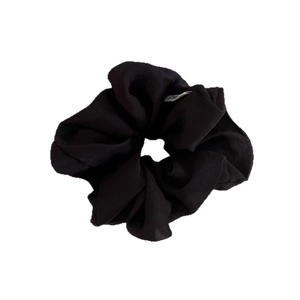 Minimalist black chiffon hair scrunchie with soft pleated texture on white background