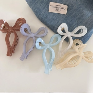 Five assorted sweet bow hair claws in resin and acetate for elegant summer updos