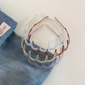 Set of four translucent wavy anti-slip headbands in assorted pastel colors on denim fabric