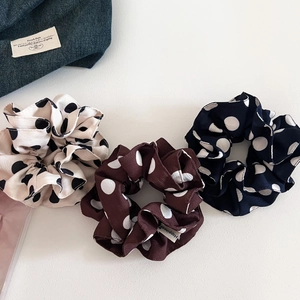 Three-piece set of retro polka dot scrunchies in cream, brown, and navy chiffon fabric