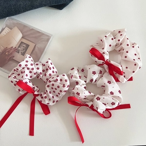 Detail showing red floral and polka dot hair scrunchies with satin ribbon bows