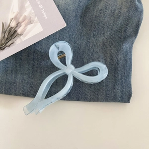 Close-up of a light blue matte bow hair claw clip with a durable metal spring