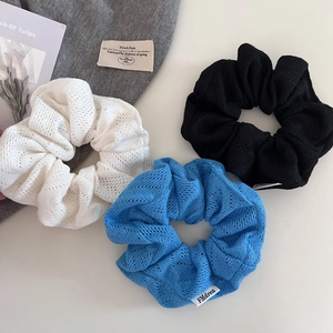 Lot de trois chouchous en maille tricotée crème, noir et bleu avec texture crochet