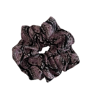 Vintage purple paisley scrunchie with silky fabric texture for elegant hair styling