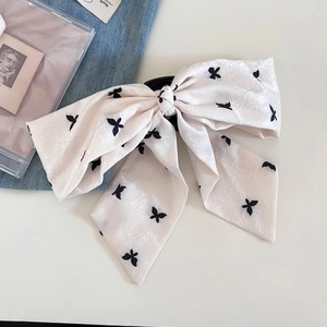 Elegant Korean style polka dot bow hair claw clip for a stylish half-up ponytail