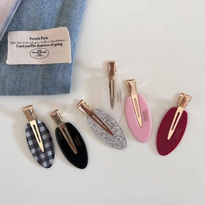 Detailed set of six acetate oval hair clips in various colors and golden metal finish