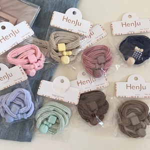 Close-up of pastel elastic hair ties with matching heart and square resin charms