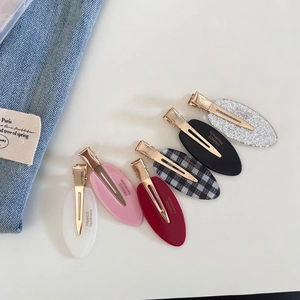 Detailed close-up of six acetate hair clips in assorted colors with France Handmade text