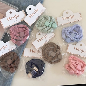 Set of high-elasticity cream-colored hair bands with cute charms on aesthetic background