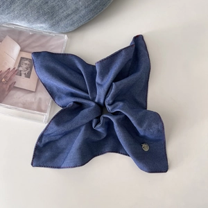 Retro denim blue oversized scrunchie with red stitching and silver logo tag detail